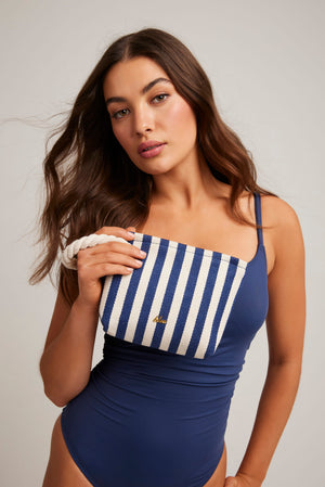 Blue and white striped Rope Wristlet Bag by Bleu Rod Beattie with a compact design and wrist strap, perfect for casual outings.
